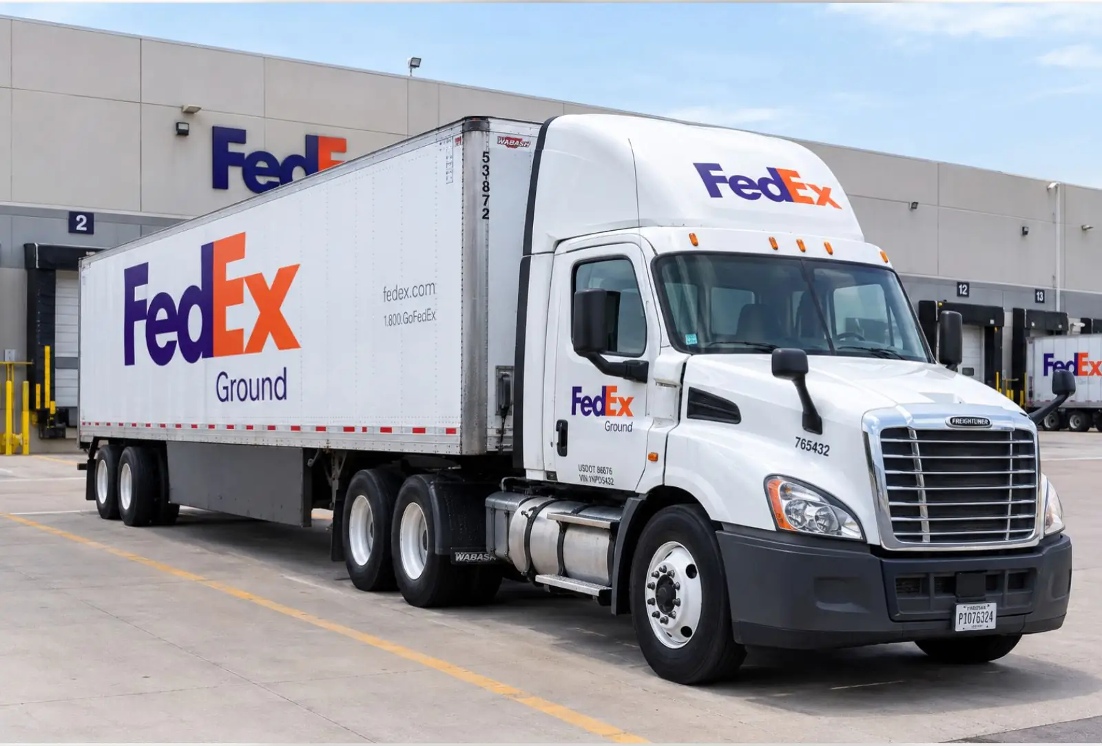 A FedEx Ground tractor-trailer parked at a distribution center loading dock